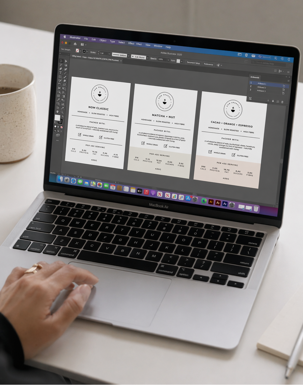Nom Granola product packaging being designed on a laptop